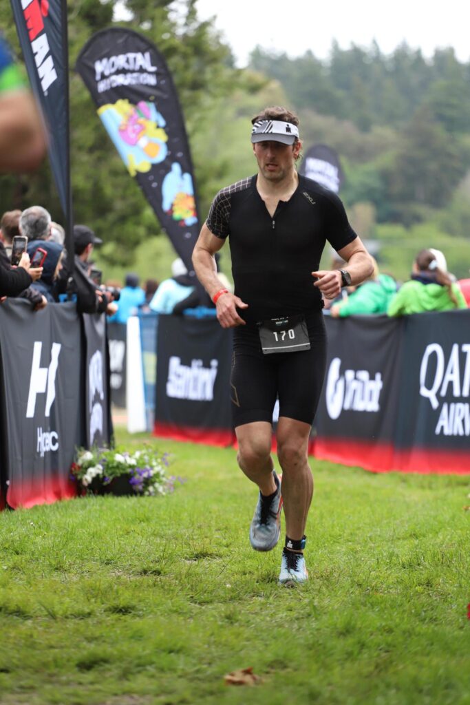 Jay running toward the finish at a 2024 triathlon